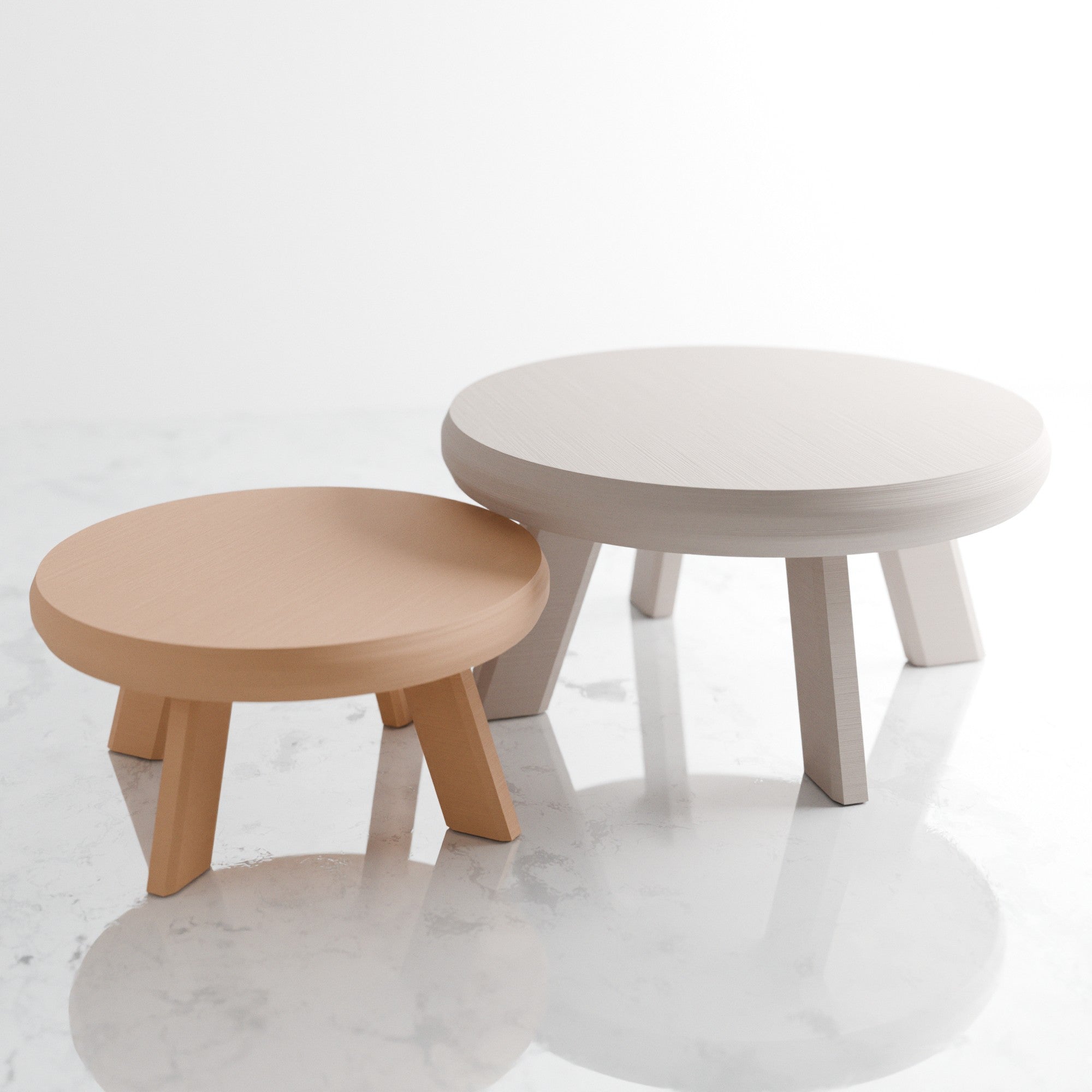 Two round tables, one beige and one gray, on a white background
