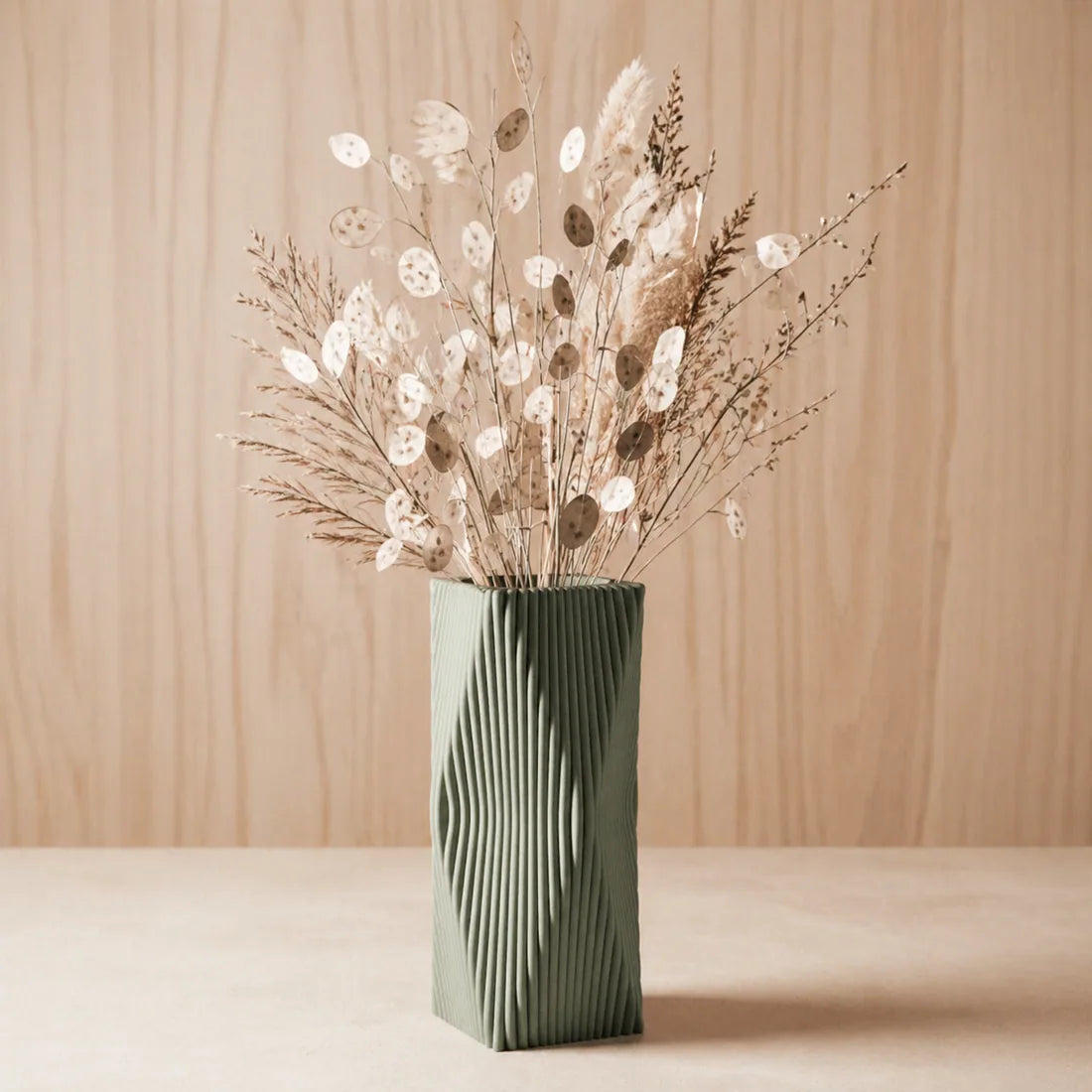 Dried florals in green ribbed vase