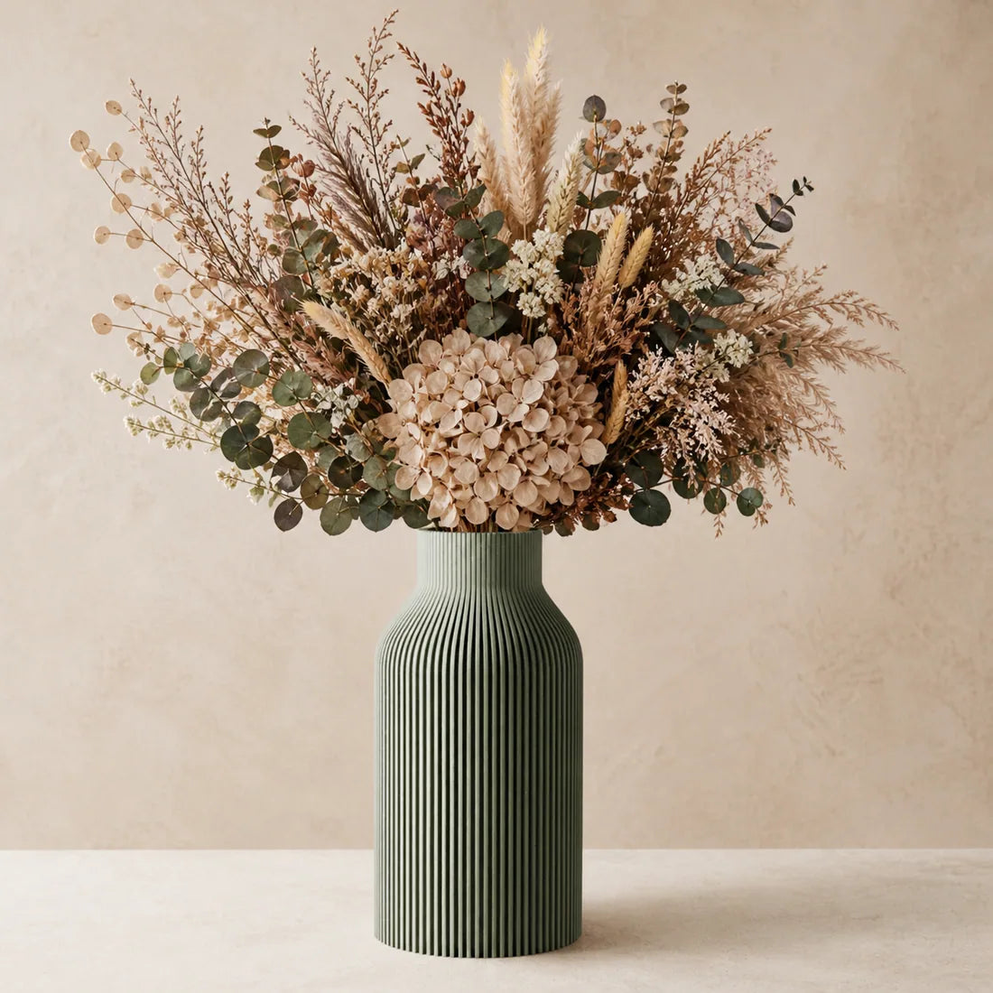 Dried floral arrangement in sage ribbed vase